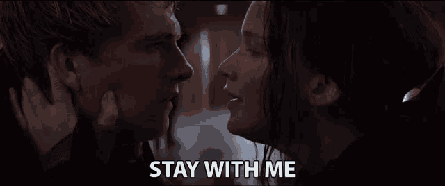 a man and a woman are kissing with the words stay with me written on the bottom