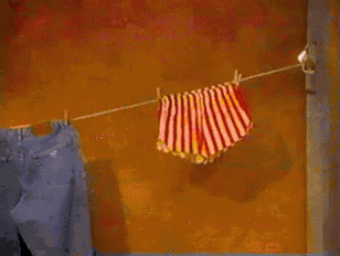 a sign that says dance your pants is hanging on a clothes line