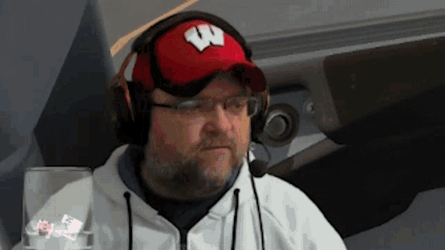 a man wearing headphones and a red w hat