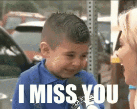 a young boy is talking into a microphone while a woman says i miss you .