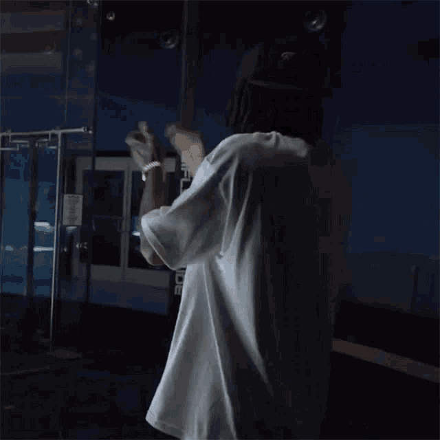 a man stands in front of a sign that says outside