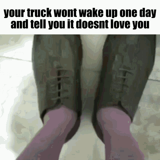 a person wearing purple socks and a pair of black shoes