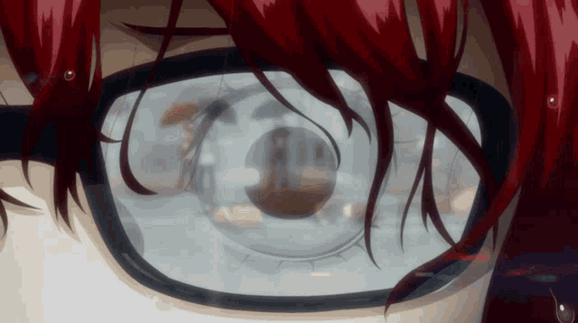 a close up of a person 's eye with a reflection of a building