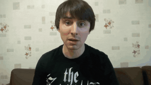 a man wearing a black shirt that says the