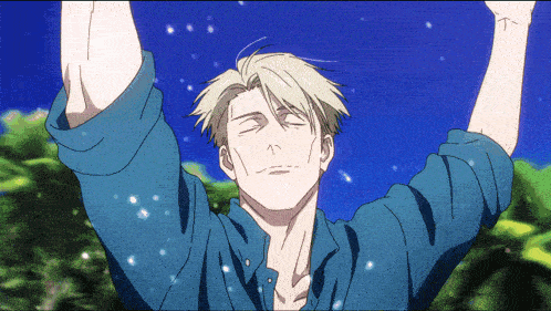 a man in a blue shirt with his eyes closed and his arms outstretched