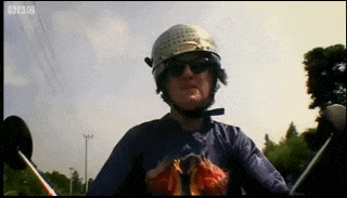 a man wearing a helmet and sunglasses is riding a motorcycle with bbc written on the bottom of the screen