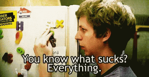 a man standing in front of a refrigerator with the words " you know what sucks everything " below him