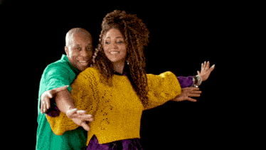 a man in a green shirt and a woman in a yellow sweater are posing for a picture