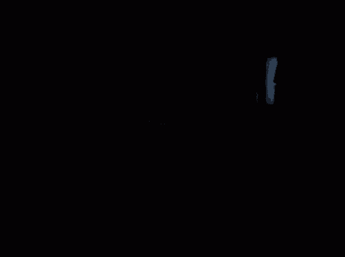 a dark room with a couch and a doorway leading to a closet .