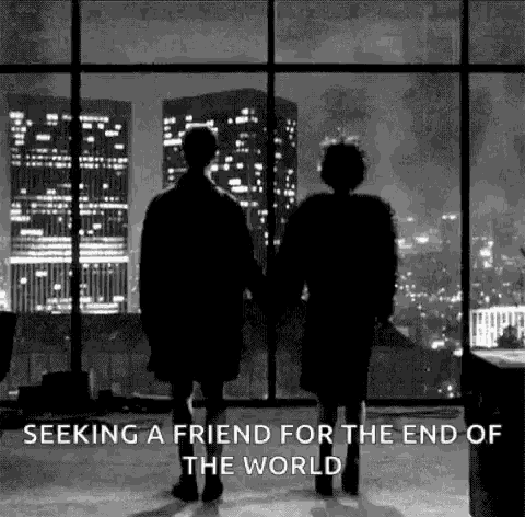 a man and a woman are holding hands and looking out a window at a city at night .