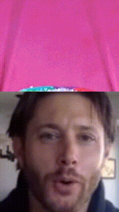 a close up of a man 's face against a pink background
