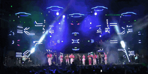 a group of people standing on a stage in front of a large screen that says ' x '
