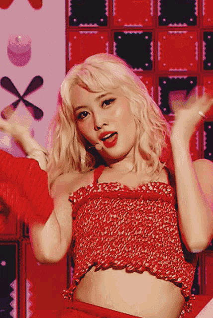 a woman in a red crop top is dancing