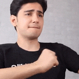 a man in a black shirt is making a face