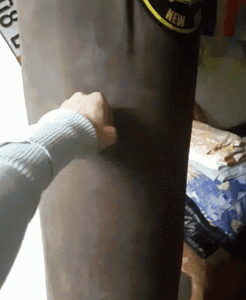 a person is hitting a punching bag with a new label on it