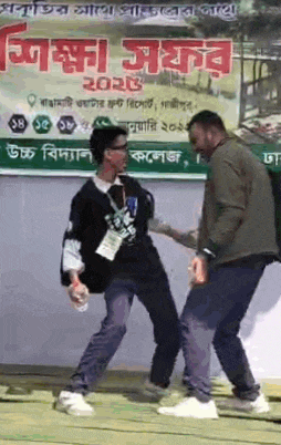 two men are dancing in front of a sign that says ' 2021 ' on it