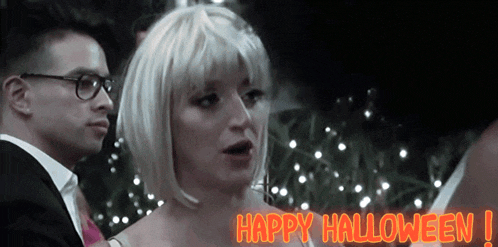 a woman in a wig says happy halloween in orange