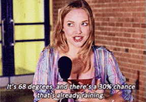 Karen Smith from the movie Mean Girls, who believes her breasts can tell the weather, is seen grabbing her breast and reporting with a microphone that it is 68 degrees and there's a 30% chance it is already raining