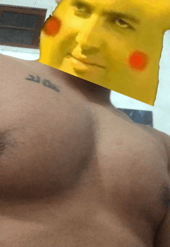 a man with a tattoo on his chest has a picture of a yellow face on his head