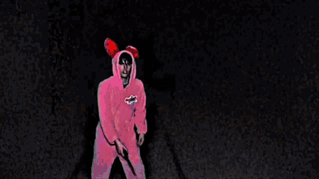 a man wearing a pink hoodie with the word coca cola on the front
