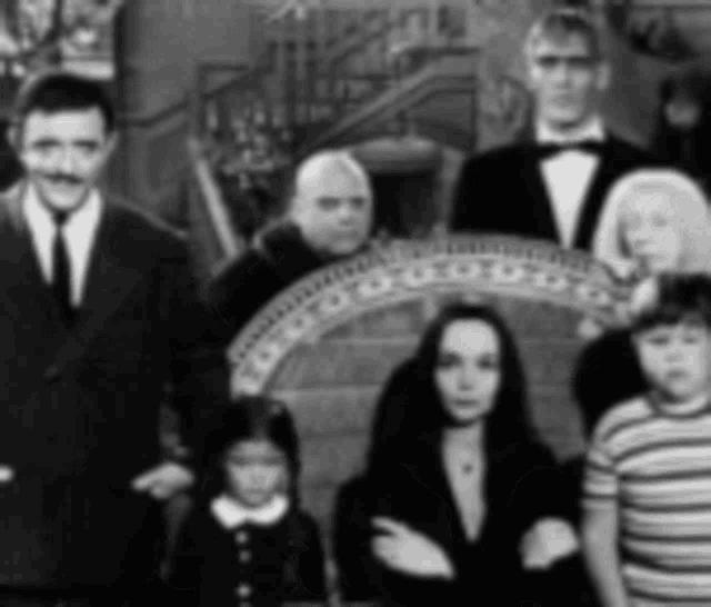 a black and white photo of a family posing for a picture