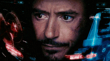 a close up of a man 's face with a screen behind him that says ' avengers '