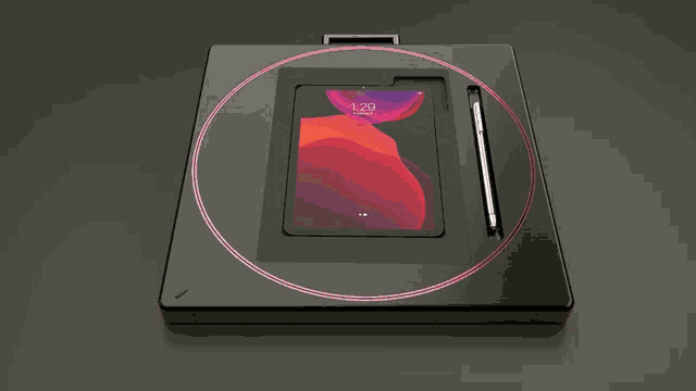 a tablet is sitting on top of a black tray with a pencil in it