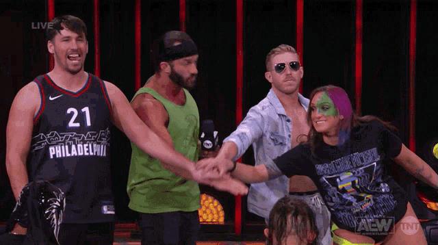 a group of wrestlers including one wearing a jersey that says 21