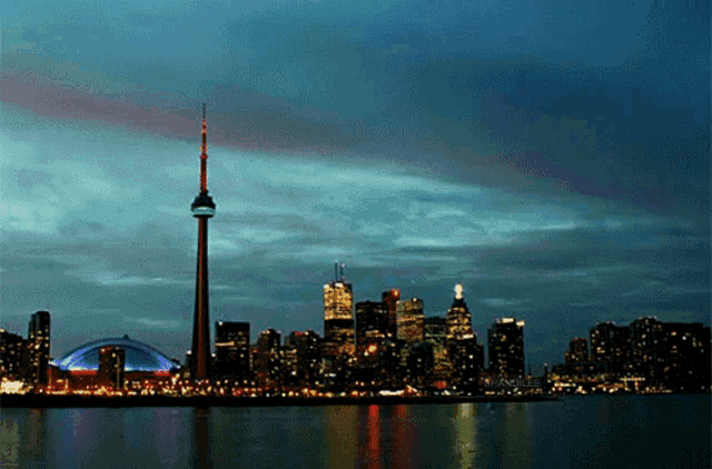 a city skyline with a very tall tower in the middle