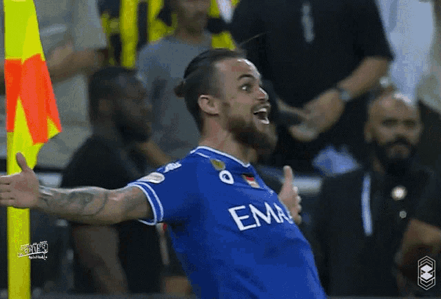 a soccer player wearing a blue shirt that says ema