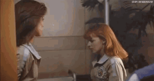 a couple of women are standing next to each other in a room .