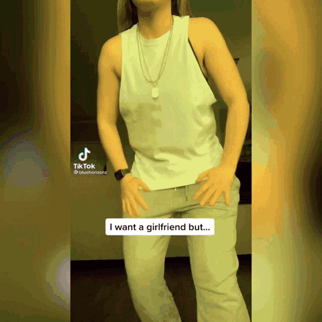 a woman in a white tank top and grey pants is dancing with a caption that says i want a girlfriend but