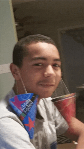 a young man wearing a happy birthday bandana and a party hat
