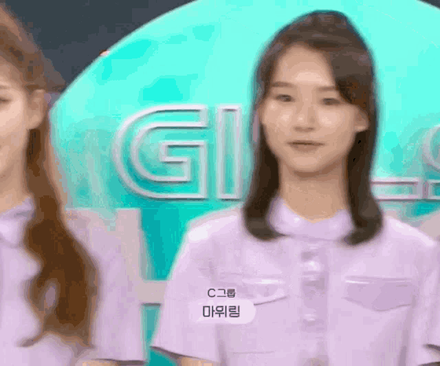 a girl in a purple shirt has a name tag that says c.