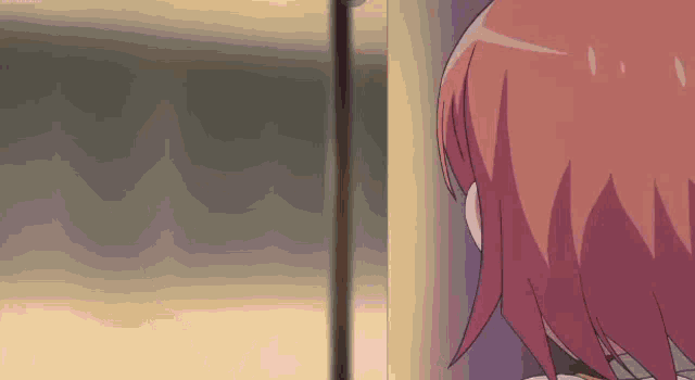 a girl with red hair is standing in front of a wall .