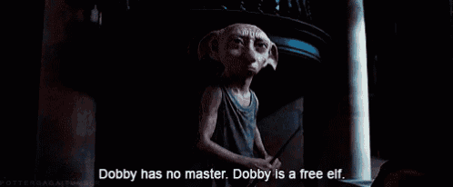 a dobby from harry potter is standing in a dark room .