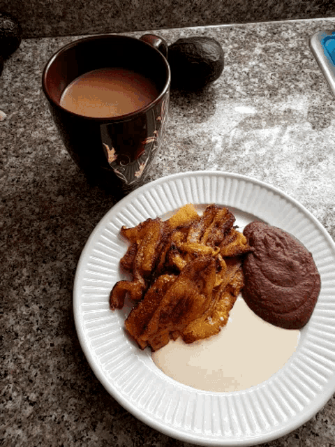 a plate of food is next to a cup of coffee