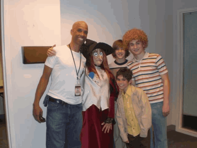 a group of people posing for a picture with one wearing a lanyard that says ' id '