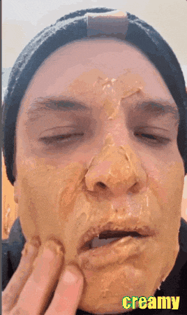 a close up of a person 's face with creamy written on the bottom right
