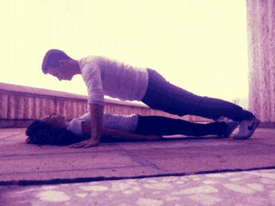 a man and a woman do push ups together