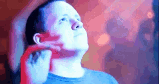 a man in a blue shirt is looking up in a blurry photo