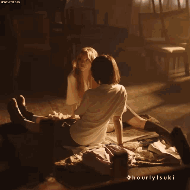 a couple of girls sitting on the floor with the hashtag hourlytsuki on the bottom