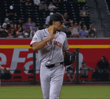 a baseball player for the san francisco giants is standing on the field