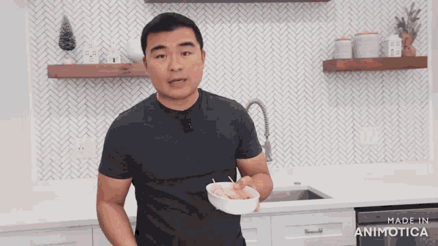 a man holding a bowl of food in a kitchen with the words made in animatica on the bottom