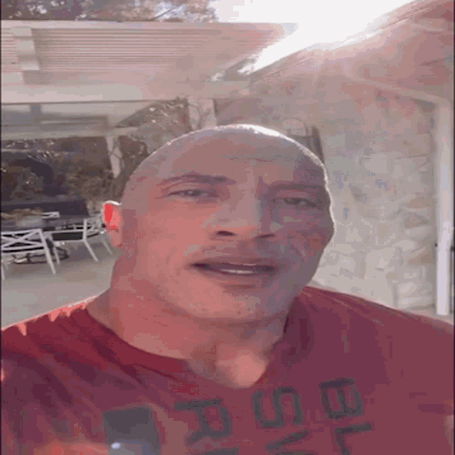 a bald man is wearing a red shirt that says rsd