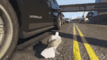 a black land rover is driving down the road