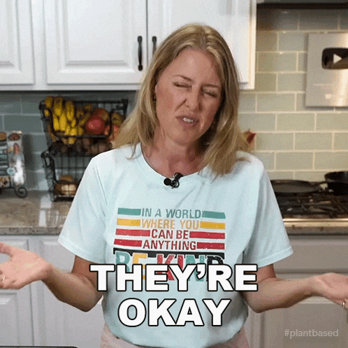 a woman wearing a shirt that says they 're okay