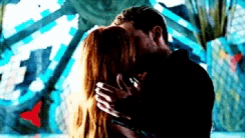 a man and a woman are hugging and kissing