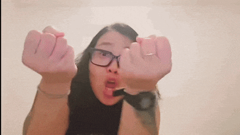 a woman wearing glasses and a watch making a funny face
