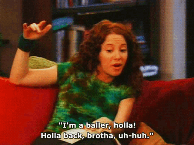 a woman sitting on a couch says " i 'm a baller, holla "